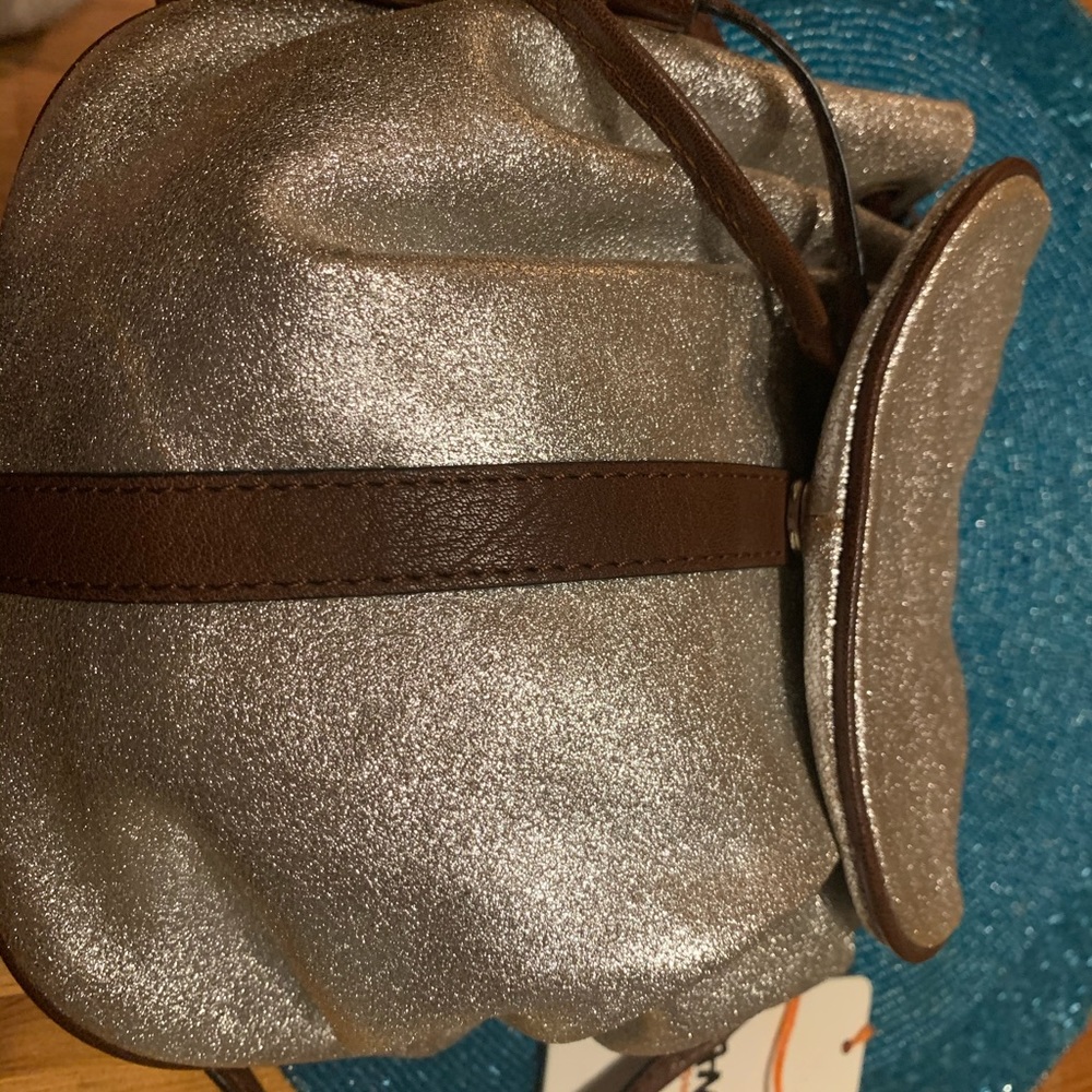 Cross body or on shoulder.